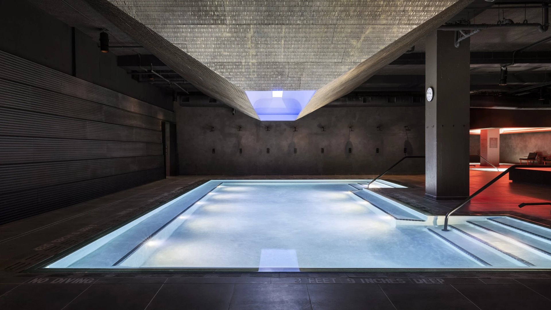 The thermal pools at Bathhouse Flatiron, bathed in red and blue light